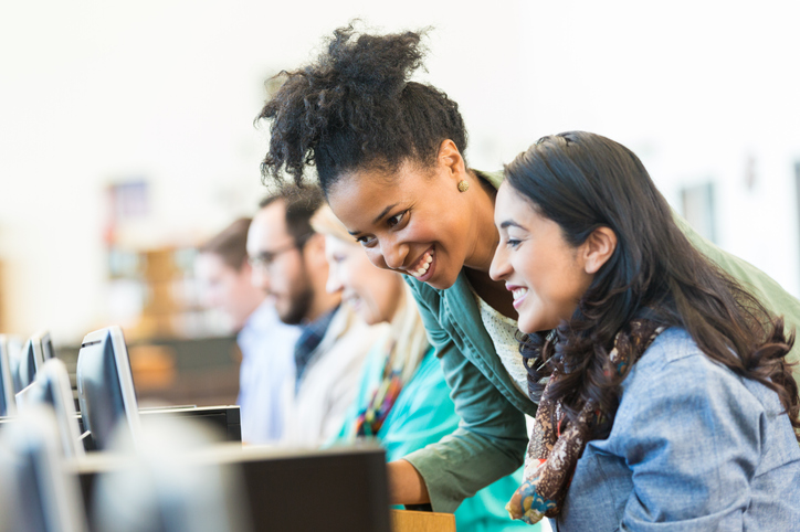 adult student learning on computer with help