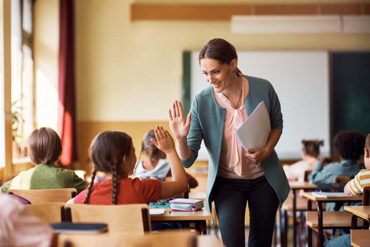 teacher giving student a high five